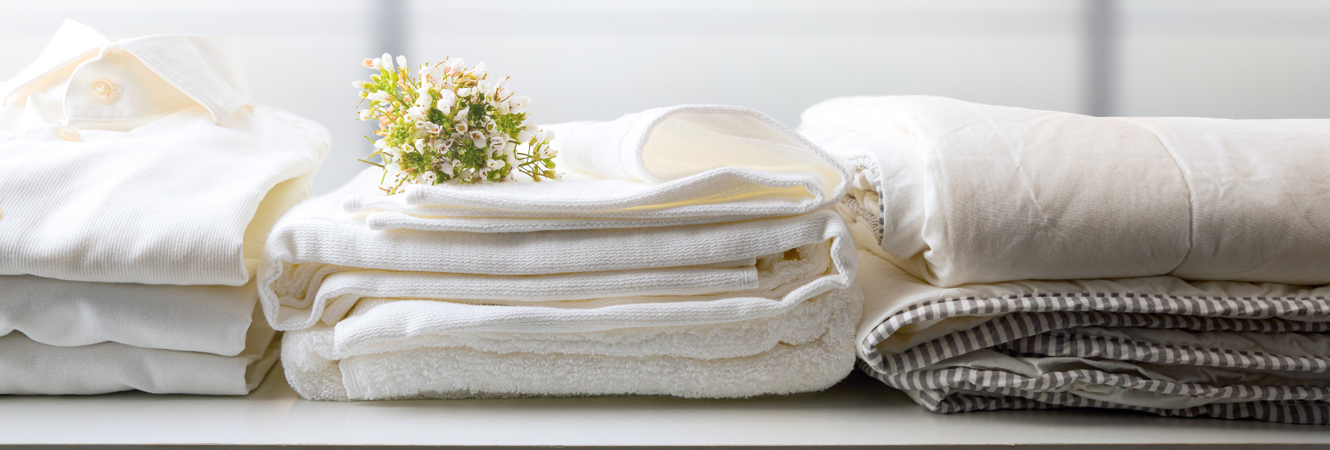 Folded Laundry At Laundromat With Florals 1920X650